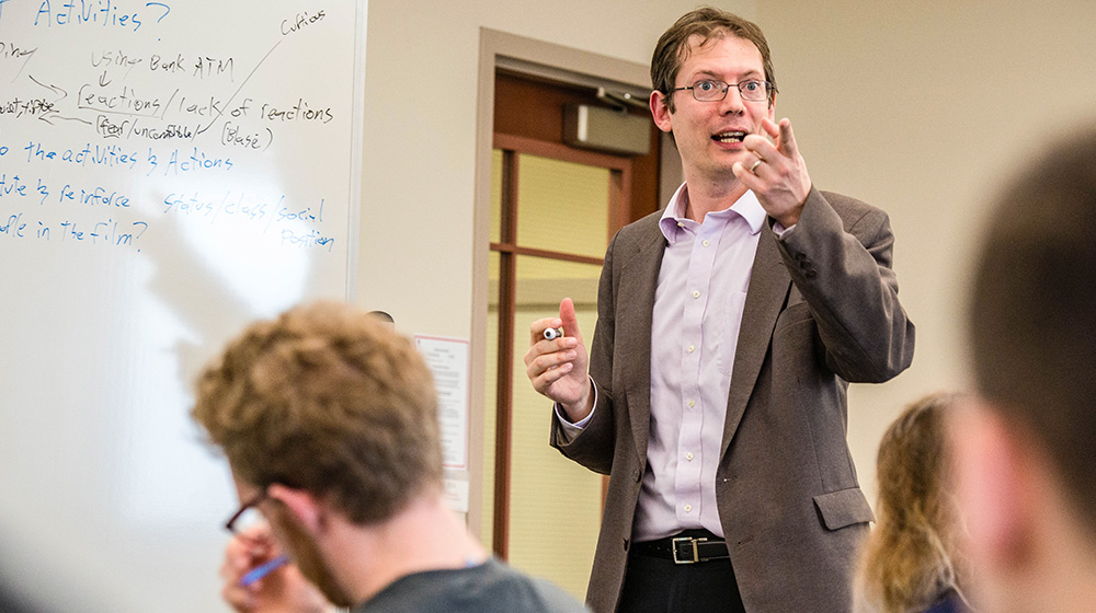 Sociology Professor Peter Rosenblatt lectures to his students during an undergraduate sociology course in Mundelein
