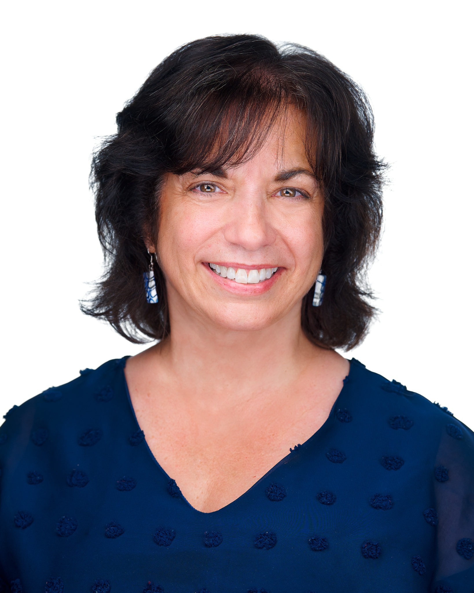 Smiling woman with dark hair against a plain background.