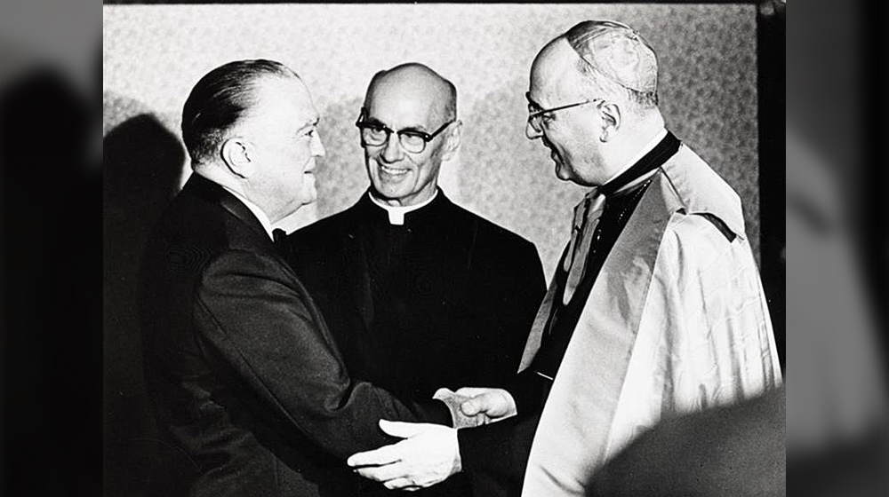 J. Edgar Hoover (left) shakes the hand of Cardinal Meyer (right) while President James Maguire, S.J. (center) observes. 