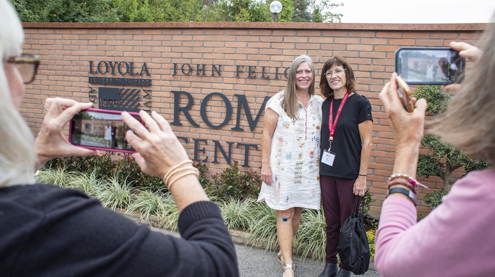 Alumni pose at the entrance to the Rome Center