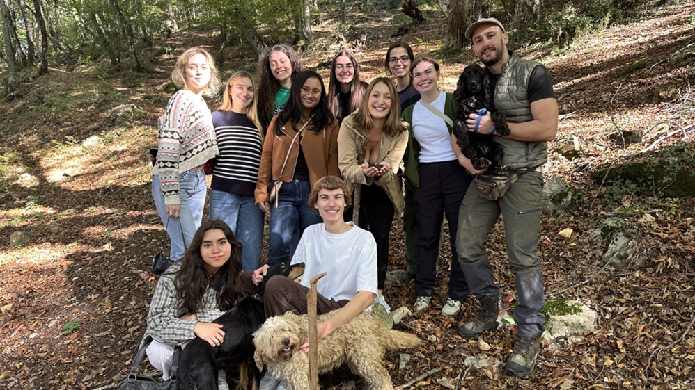 Students pose with truffle hunters and dogs Students pose with truffle hunters and dogs
