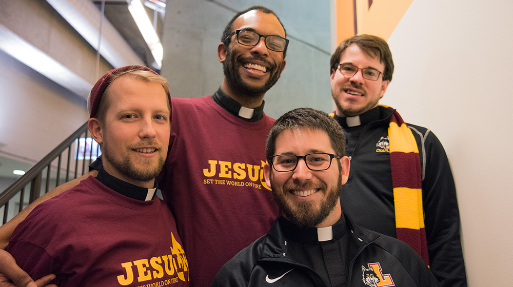 Four Jesuits smiling