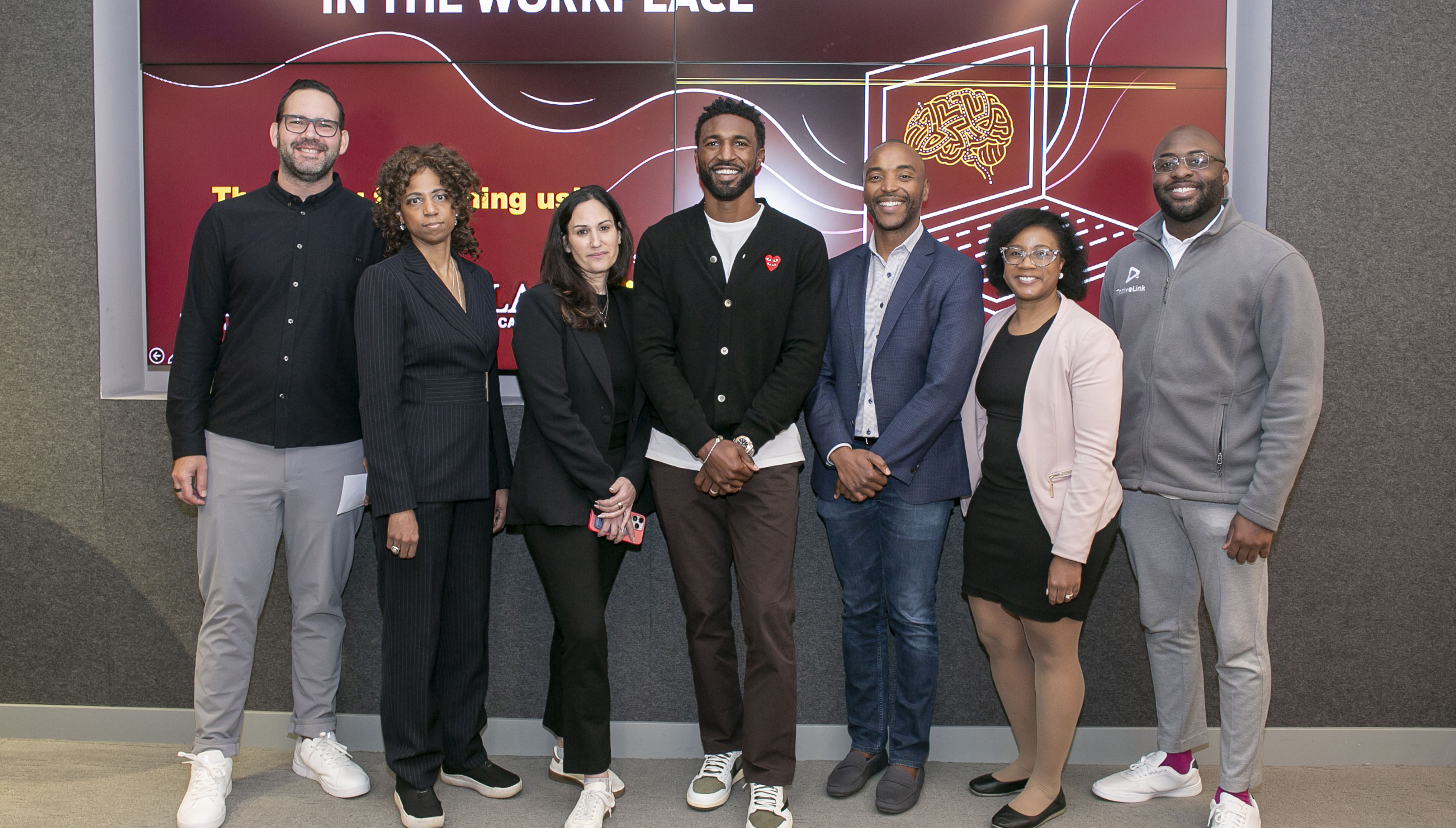 Seven finalists standing in front of Health Equity Quest screen