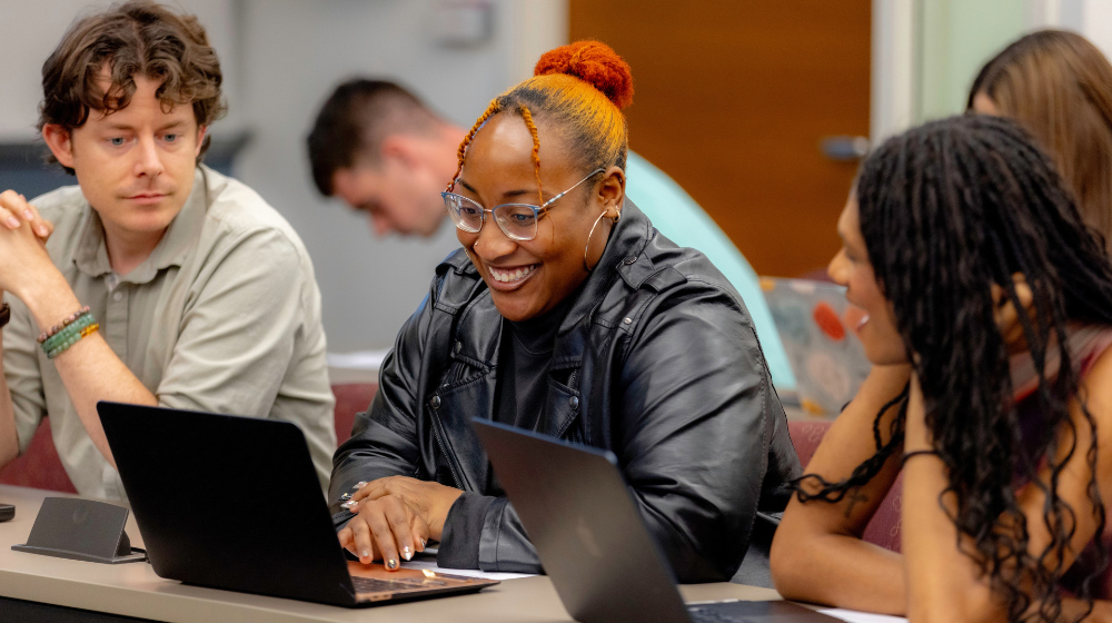 Students work together on laptops