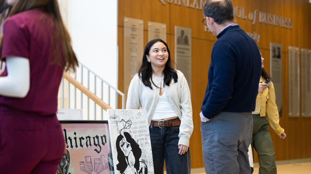 Alumni chat in the lobby of the Schreiber Center