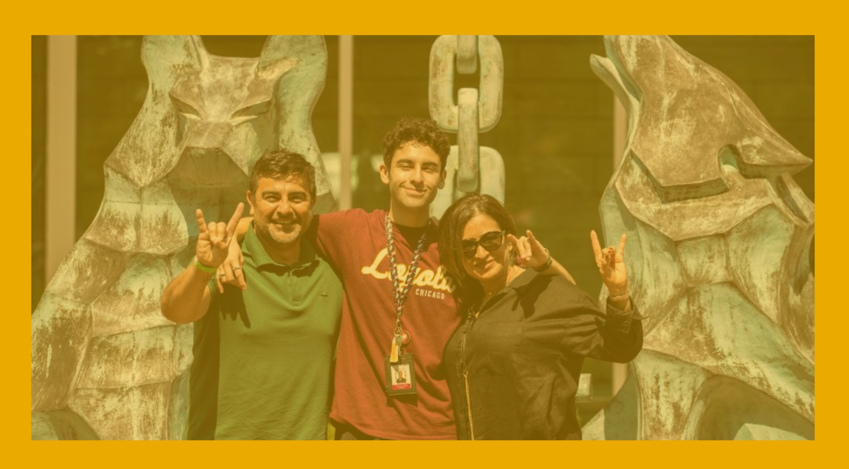 Loyola University Chicago student stands with family members on campus, smiling and posing in front of the Wolf and Kettle sculptures