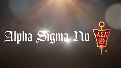 Alpha Sigma Nu title with crest on a dark, light-flared background.