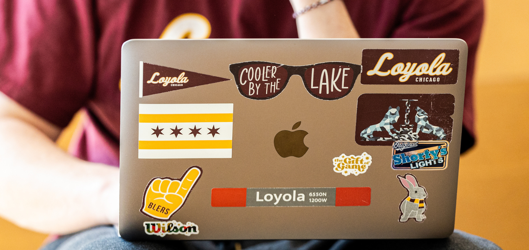 Loyola student sitting with computer