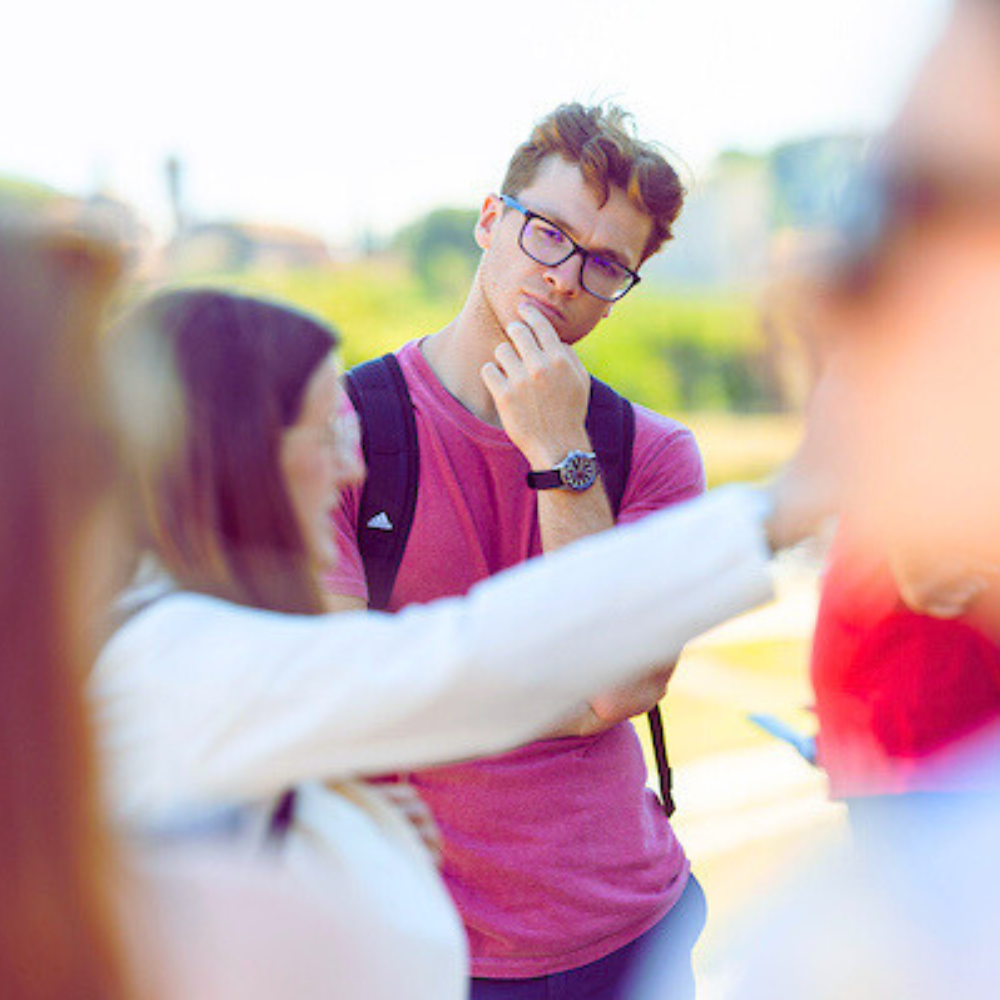 Loyola University Chicago students standing outside having a friendly debate