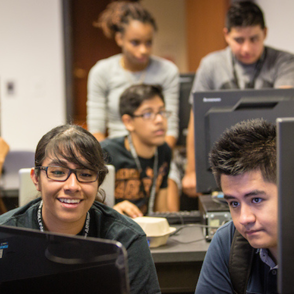 Students sit in front of computers in LUC's lab