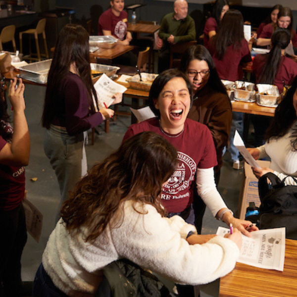 Loyola students laughing during a group project