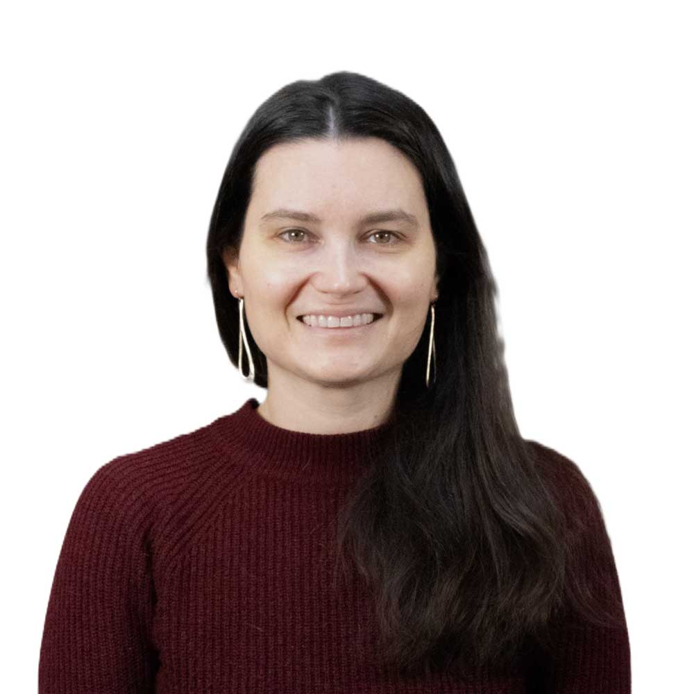 Professional headshot of a smiling woman with long dark hair wearing a maroon sweater on a light background