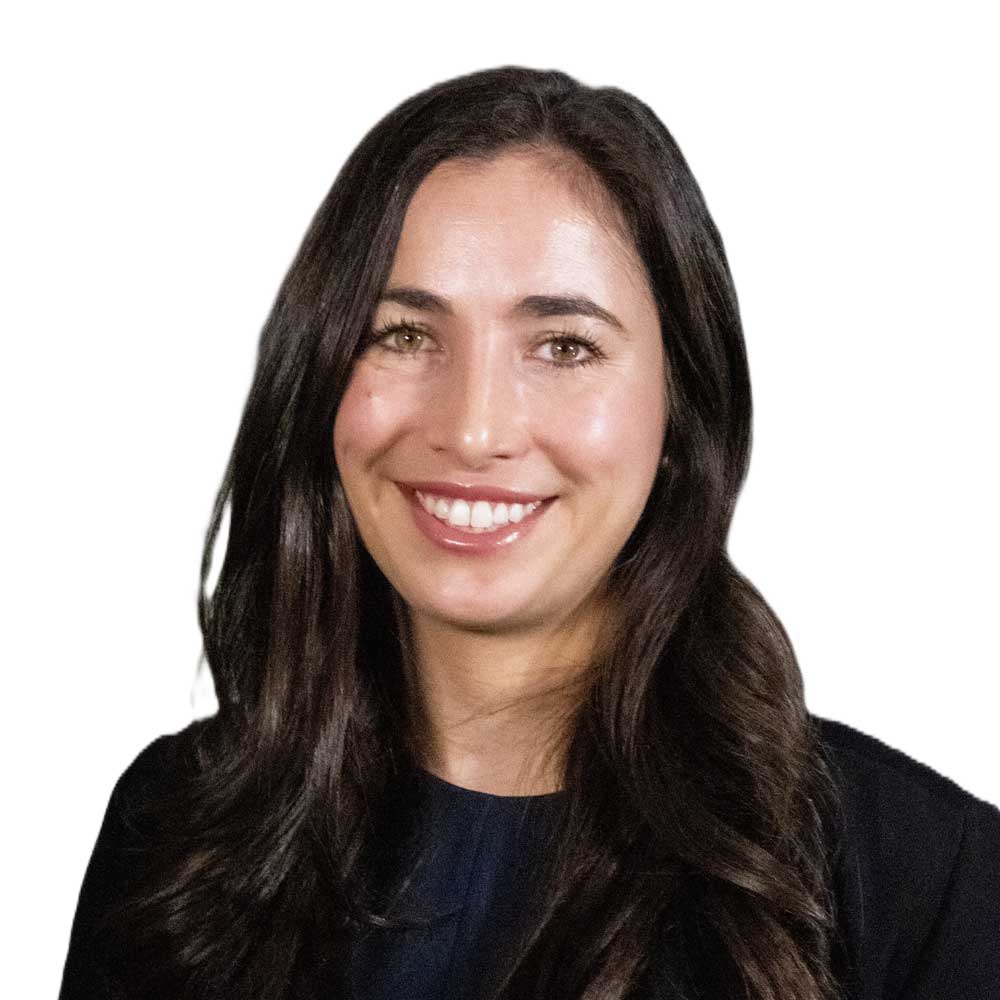 Professional headshot of a smiling woman with long dark hair on a light background