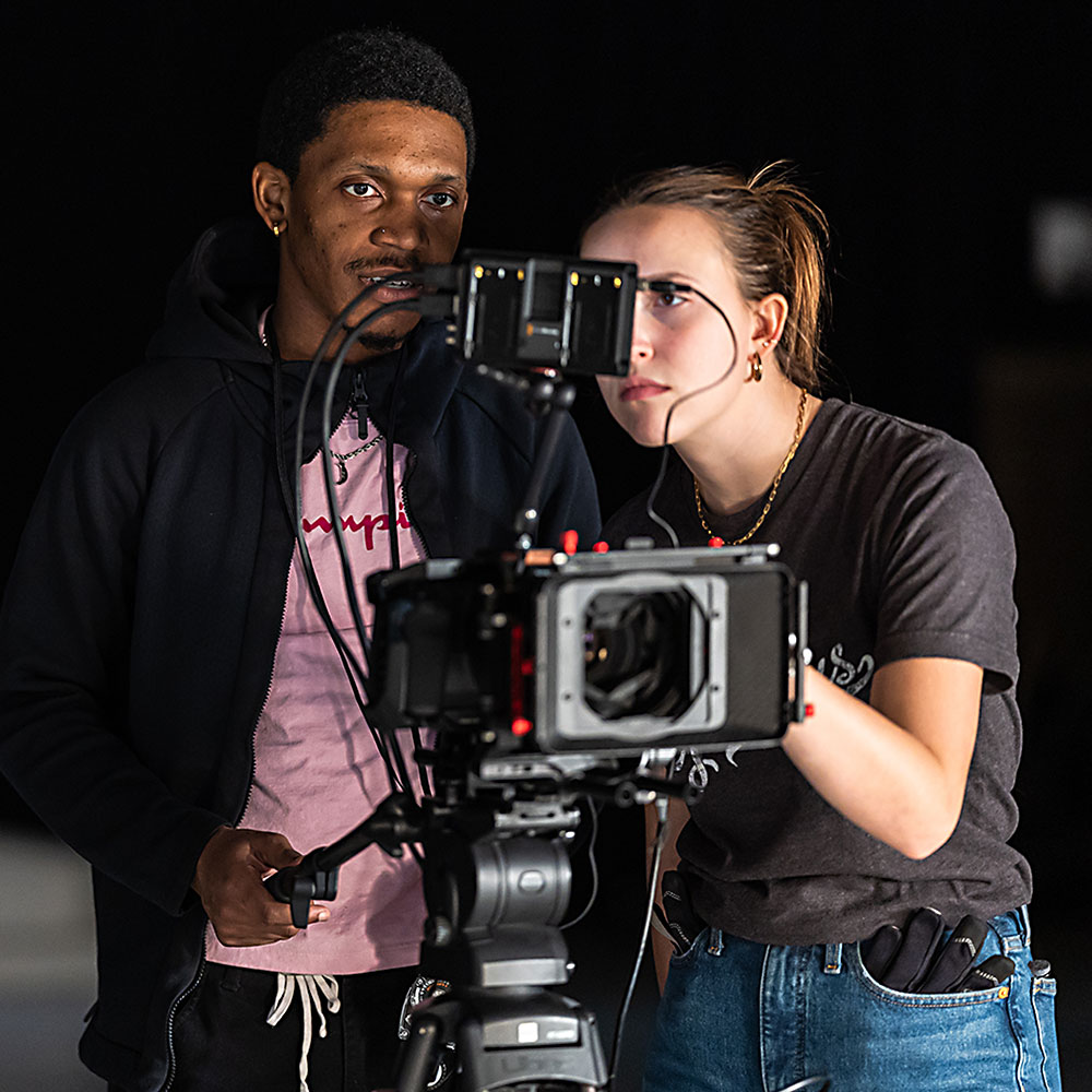 A Loyola University Chicago professor advises a student during film class.