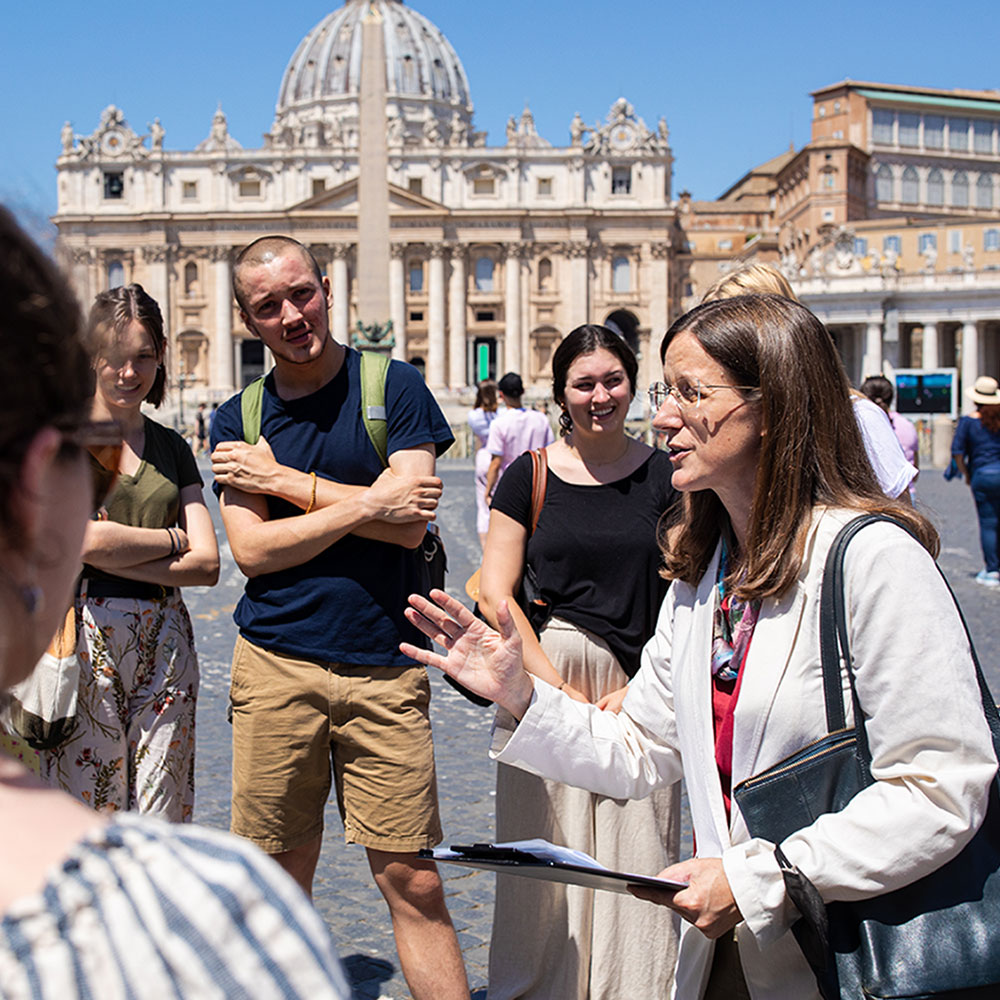 A Loyola University Chicago John Felice Rome Center professor teaches a group of students at an open plaza in Rome.